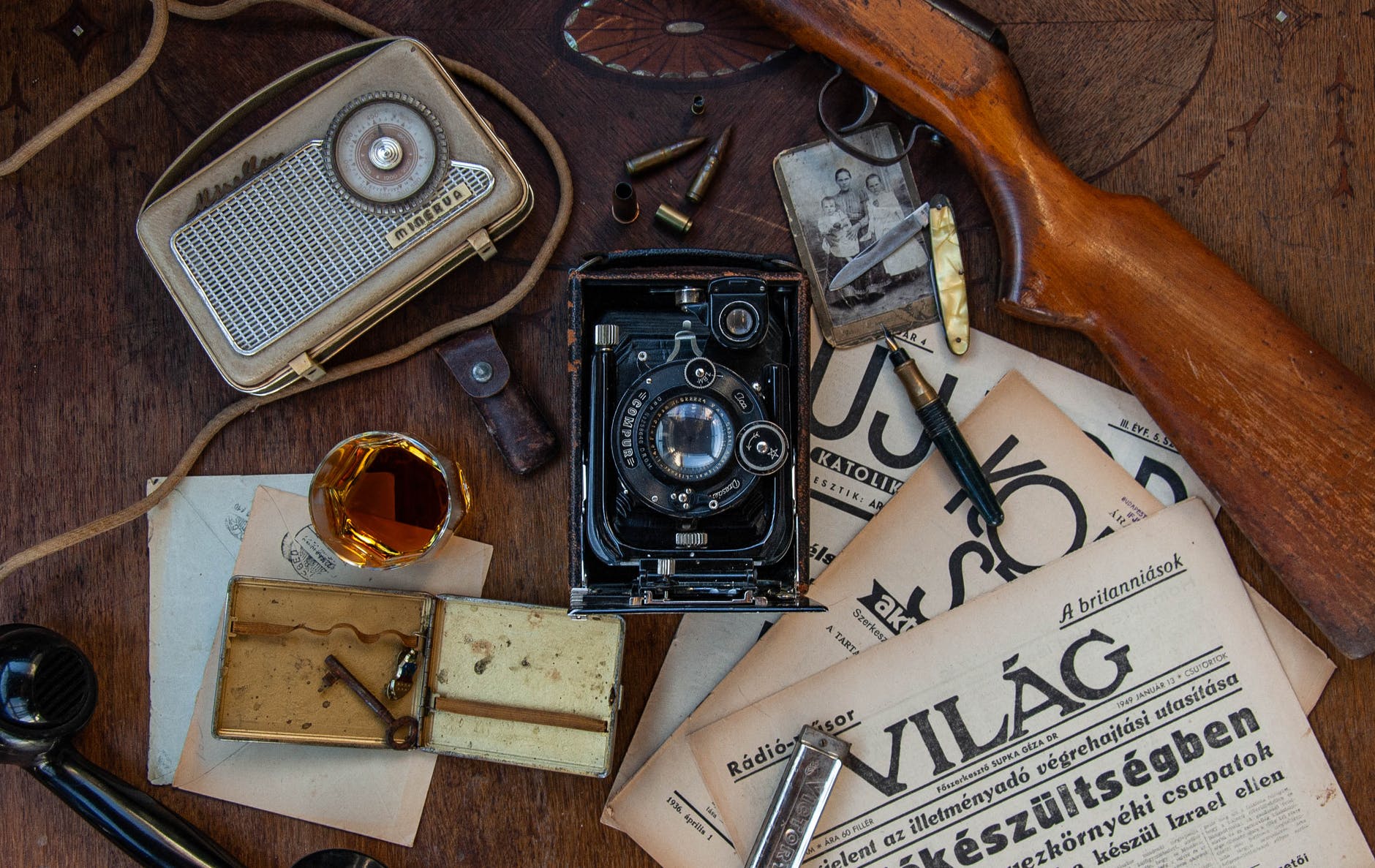 black and silver antique camera on brown wooden table